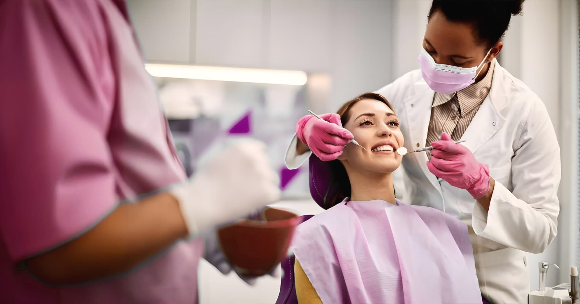 Dental professional treating a smiling patient at a ClearPath clinic